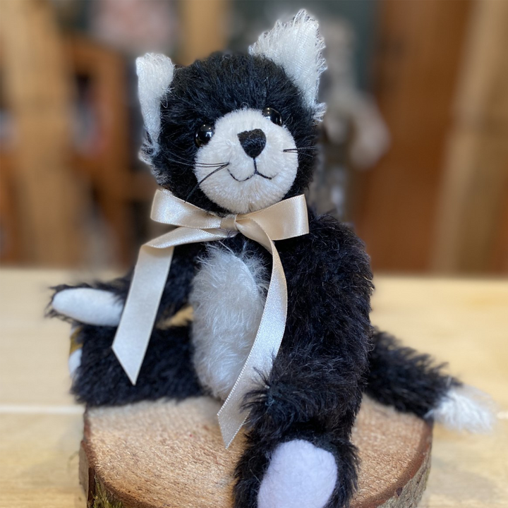 Merrythought's delightful cat has been skilfully made from jet black mohair, contrasted with pure white inner ears and tummy.