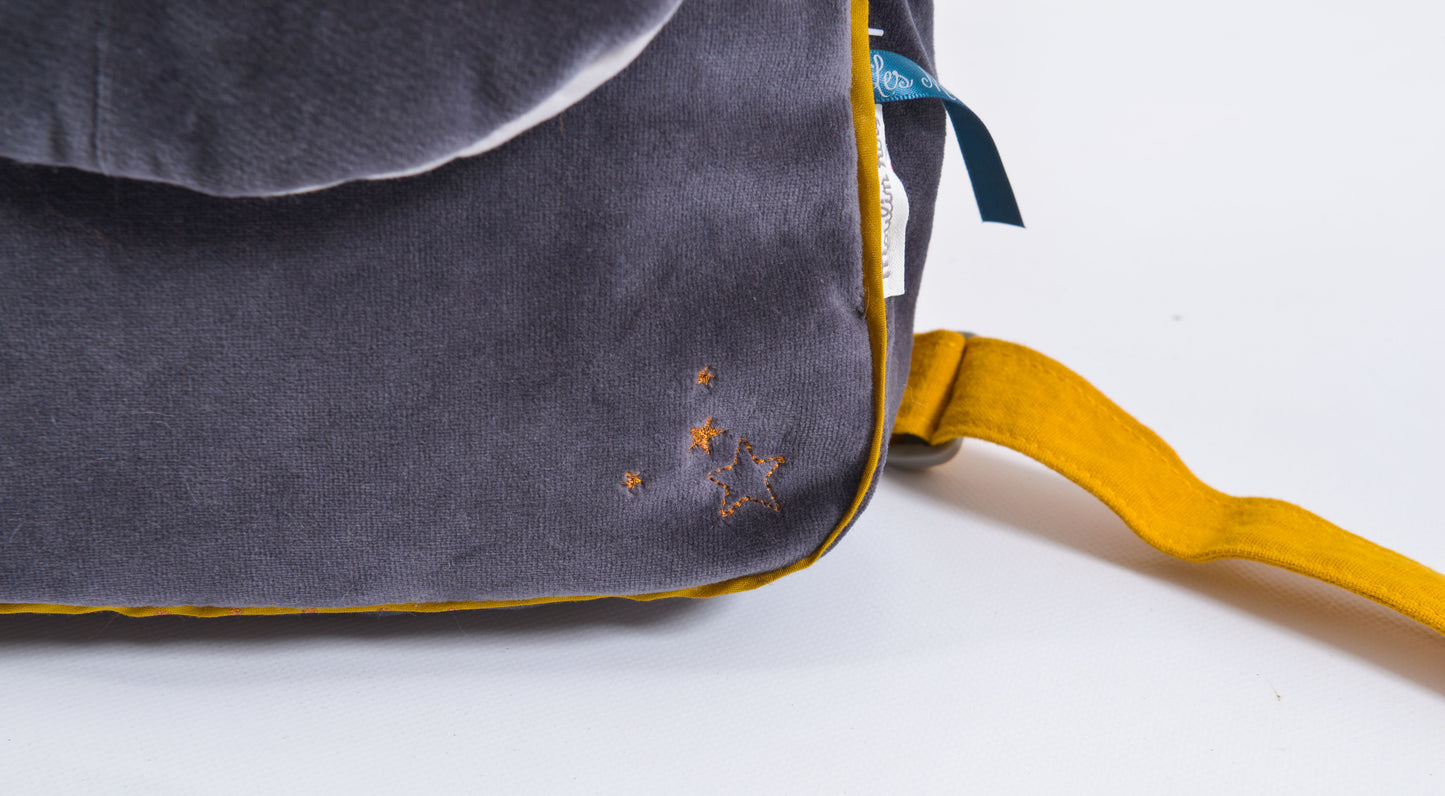 'Les Moustaches Alphonse Backpack' by Moulin Roty. Made from a soft dark grey velour material, this cute accessory comes with beautiful detailing and adjustable mustard yellow straps.