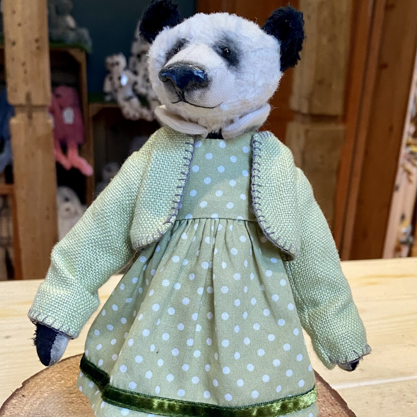Samantha Salter-Rafferty is from West Sussex, and hand-makes the most outstanding and beautiful bears and animals full of character. Each one is made with viscose and sawdust, and is lovingly dressed with style and precision.  Gorgeous Gill is wearing a pale green spotty dress with matching jacket and shoes.  Her dress is finished a beautiful velvet trim.