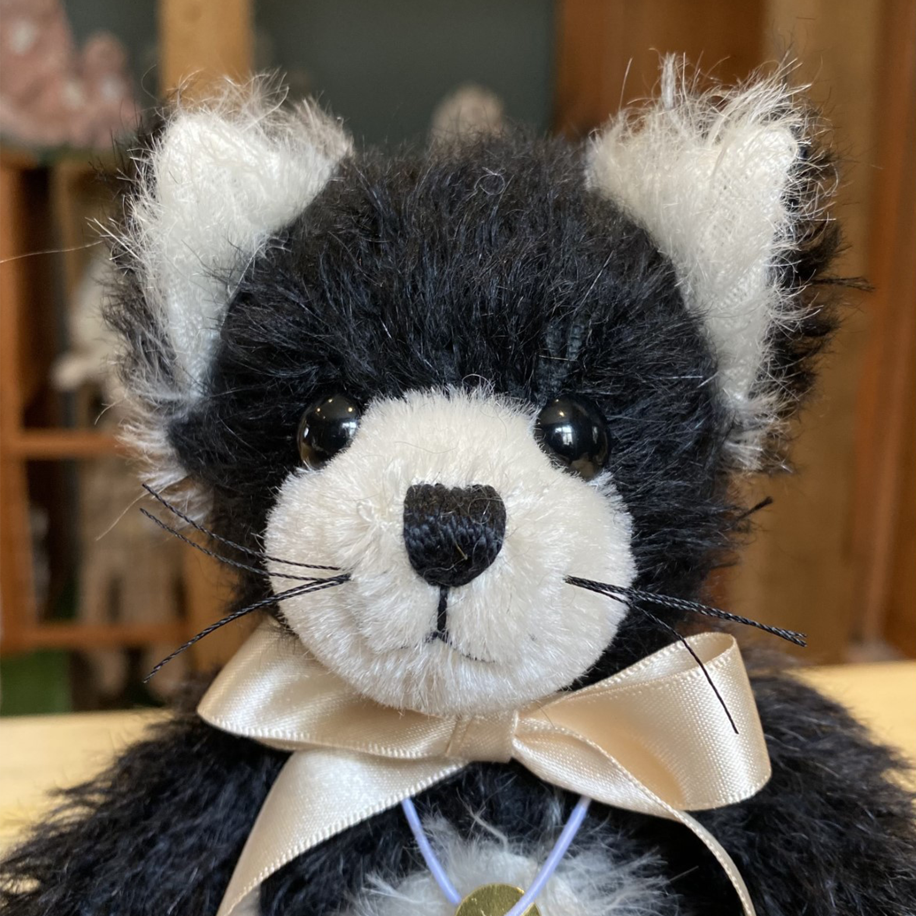 Merrythought's delightful cat has been skilfully made from jet black mohair, contrasted with pure white inner ears and tummy.
