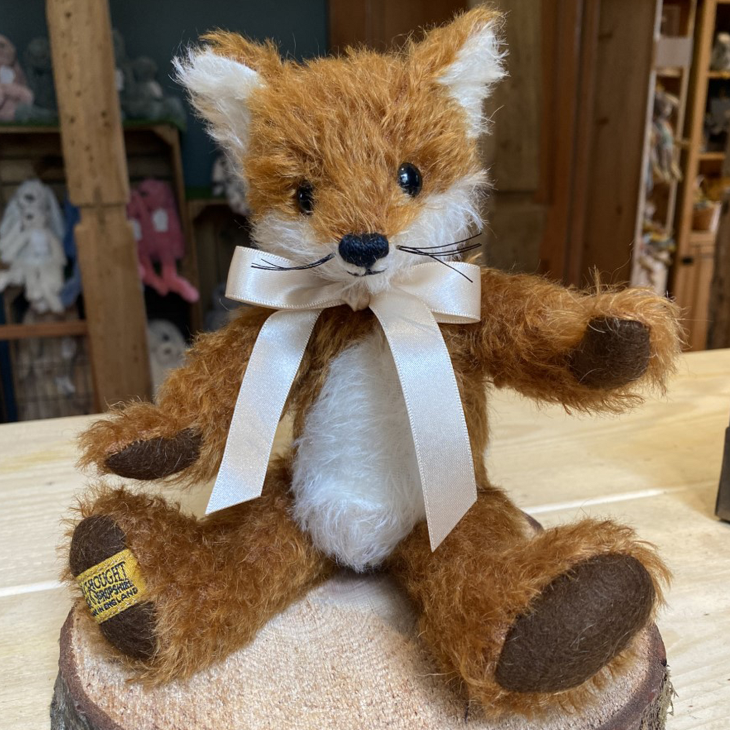 With all the charisma of a real-life wily fox, Freddy is simply irrestible. Hand-crafted from traditional white and copper-brown mohair, he proudly displays a magnificent white-tipped 'brush' tail, whilst cheeky smile and whiskers upon his pointy snout really enhance his unique personality.  Each Merrythought soft toy in the Traditional Collection is presented with a drawstring bag, to help keep your new companion clean and dust-free.