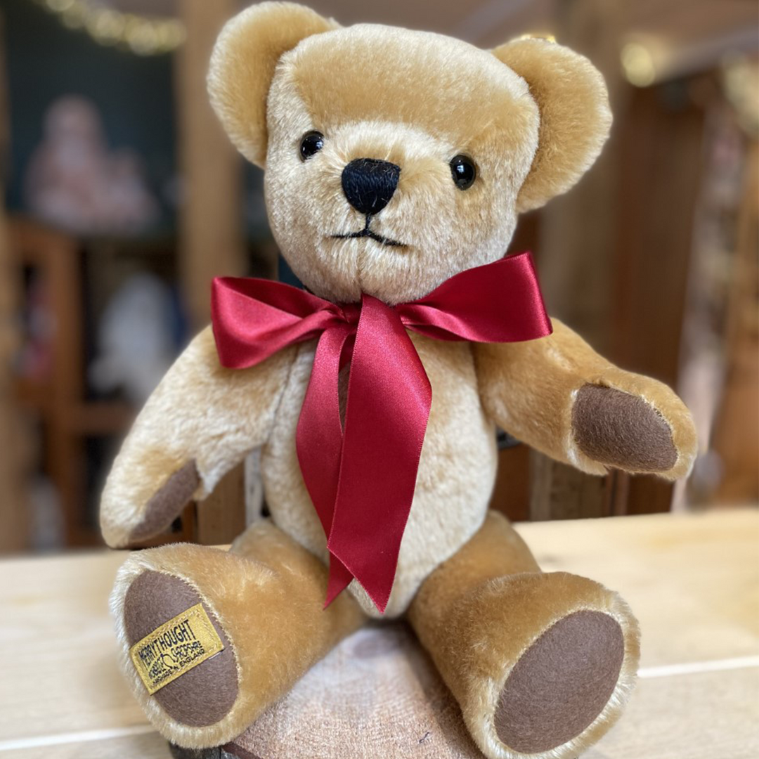 London Gold is an iconic Merrythought character, and the ultimate first teddy bear to be treasured for years to come. Expertly hand-crafted from velvety soft golden mohair, with milk chocolate wool felt paws, this bear is a true classic. A simple scarlet satin bow is the perfect accompaniment.