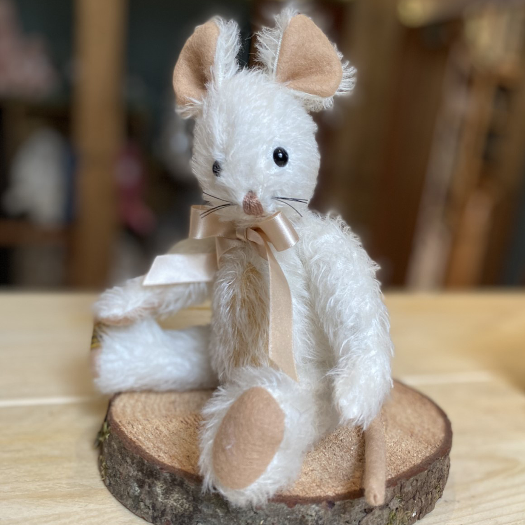 This characterful mouse has a particularly appealing expression, featuring hand-sewn whiskers and a little pinky nose. Her pure white mohair subtly contrasts a peachy-beige tummy, wool felt paws and slender tail.  Each Merrythought soft toy in the Traditional Collection is presented with a drawstring bag, to help keep your new companion clean and dust-free.