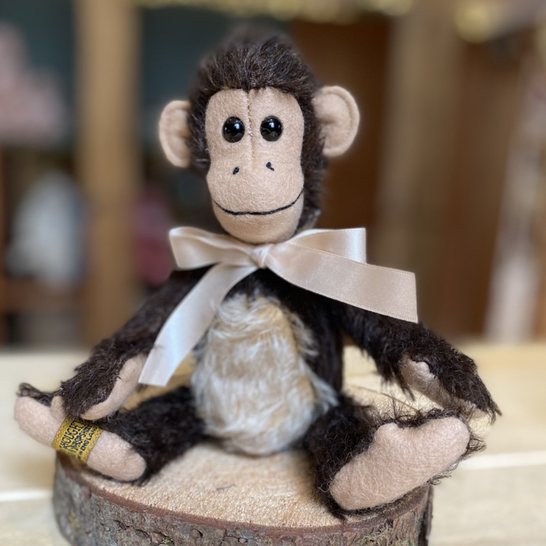 Milo's enchanting expression is sure to capture the hearts of everyone who meets him. His peachy-beige wool felt hands, feet and smiley face beautifully accompany dark-mahogany mohair, while an authentic curly monkey's tail truly brings his character to life.