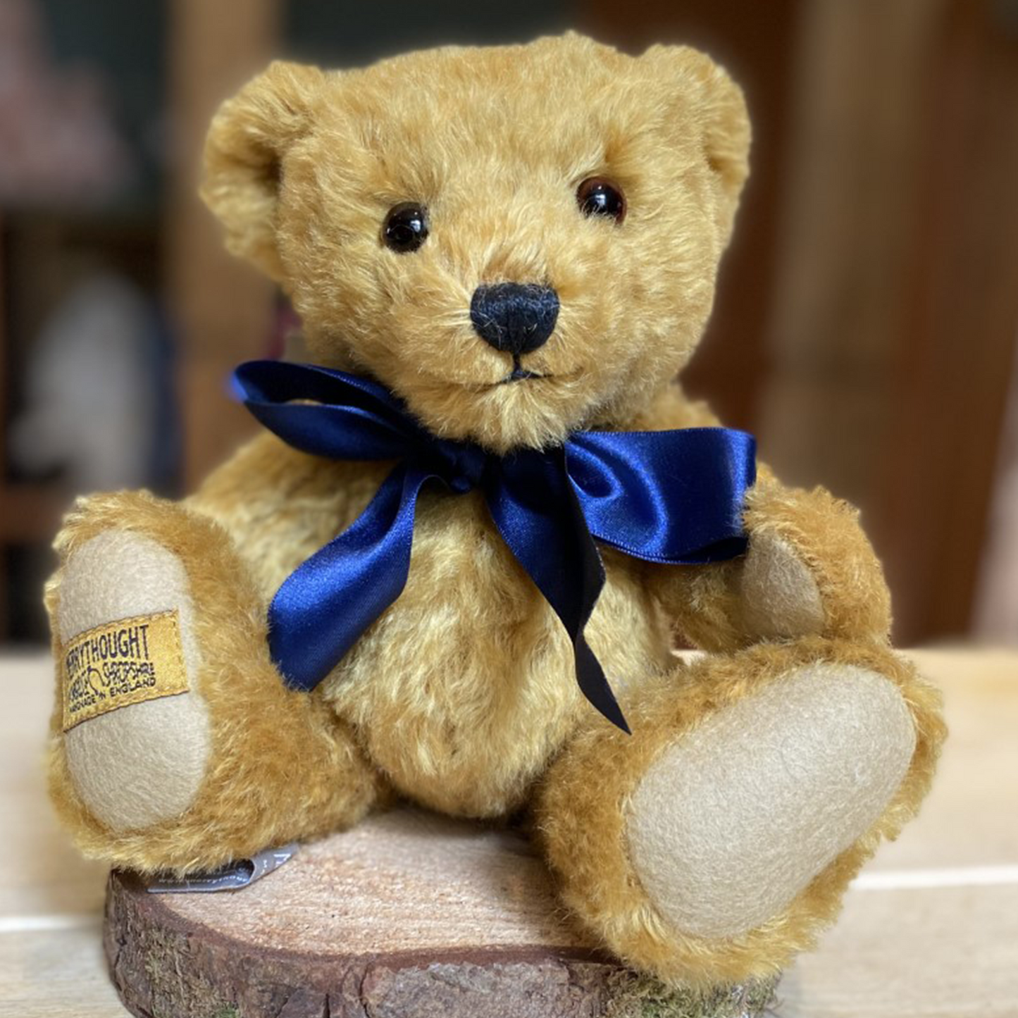Crafted from wonderfully soft, rich golden mohair, Oxford's rotund shape and characterful dark brown eyes are guaranteed to warm hearts across the generations. His colours coordinate perfectly with dark sand wool felt paws and a splendid navy blue satin bow to finish.